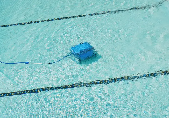 A robotic cleaner working on a pool floor